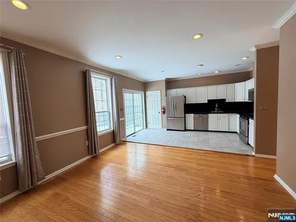 a view of a kitchen with a refrigerator and a window