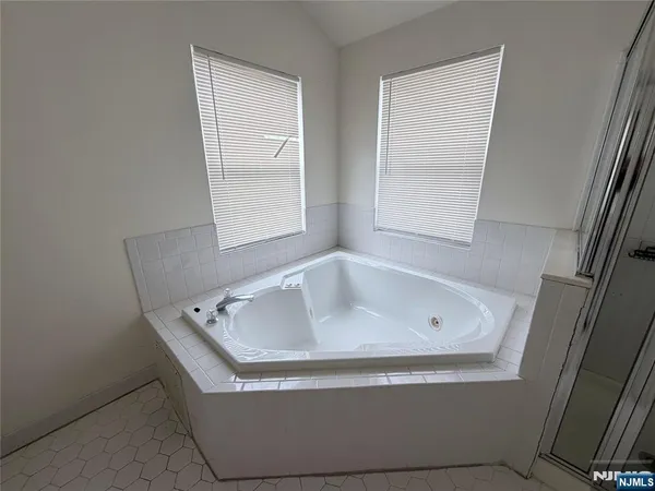 a bath tub sitting in a bathroom next to a window