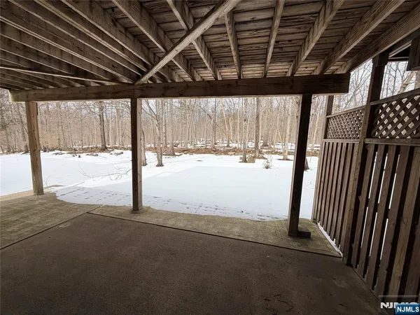 a view of empty room with wooden walls
