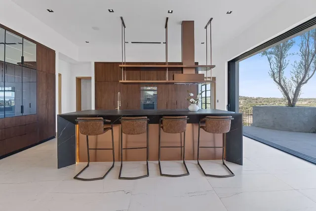 a view of a kitchen with furniture and floor to ceiling window