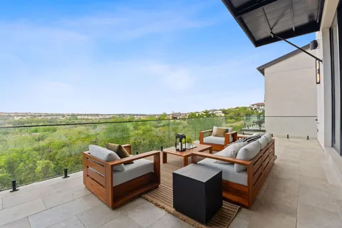 a view of couch and table and chairs in patio