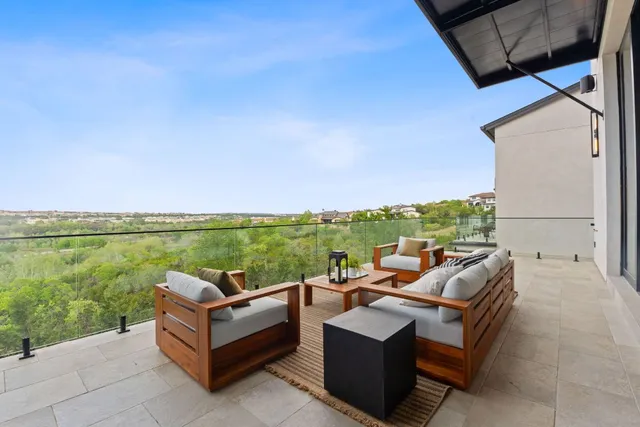 a view of couch and table and chairs in patio