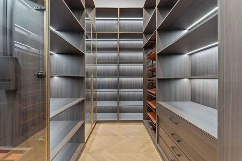 a view of walk in closet with empty racks