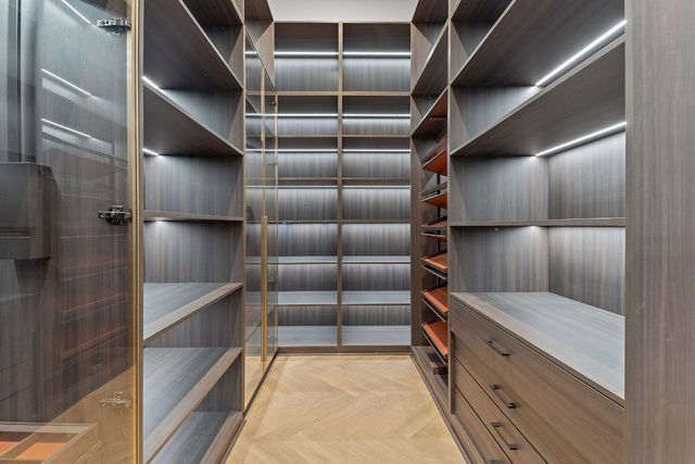 a view of walk in closet with empty racks