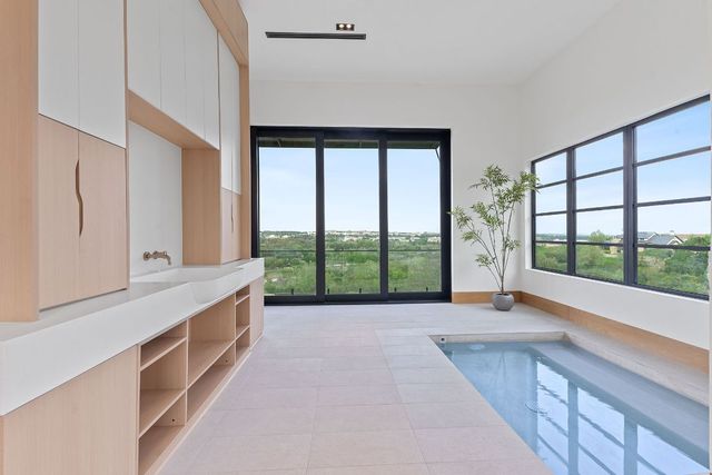 a spacious bathroom with a large window and a bathtub