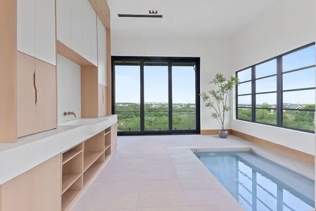 a spacious bathroom with a large window and a bathtub