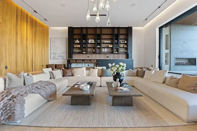a living room with furniture and chandelier