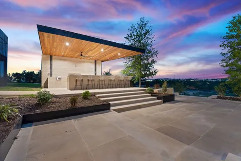 a view of backyard with barbeque grill and a potted plant