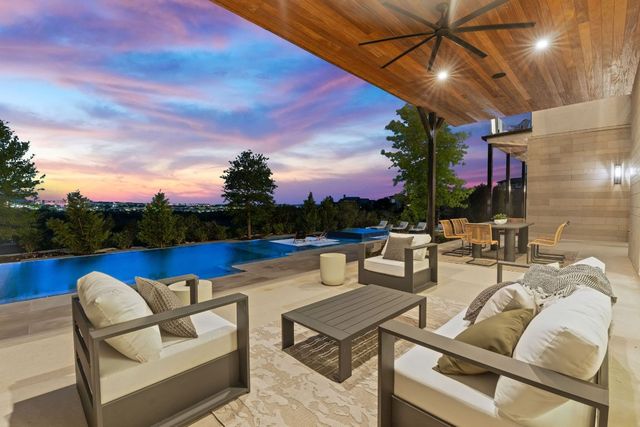 a view of a terrace with couches and pool