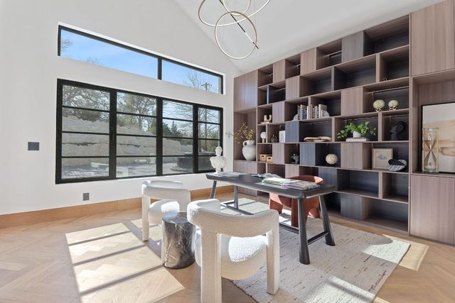 a living room with furniture a rug and a large window