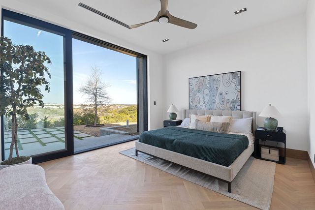 a living room with a bed furniture next to a large window
