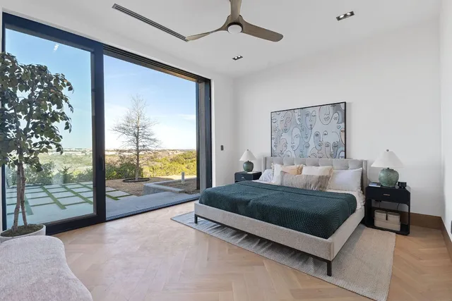 a living room with a bed furniture next to a large window