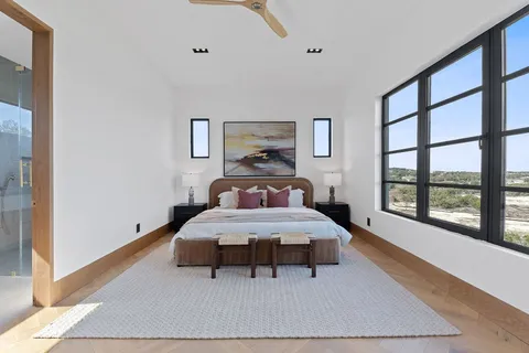 a bedroom with a bed and large window