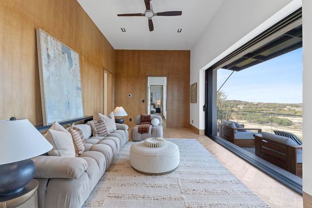 a living room with furniture and a large window