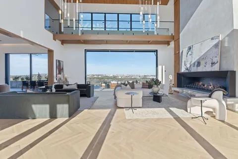 a living room with furniture a fireplace and flat screen tv