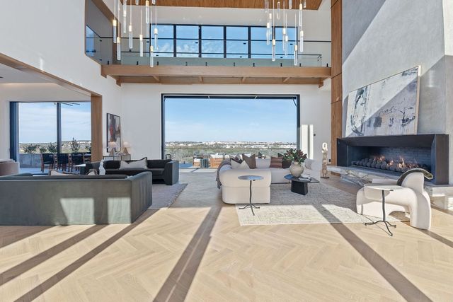 a living room with furniture a fireplace and flat screen tv