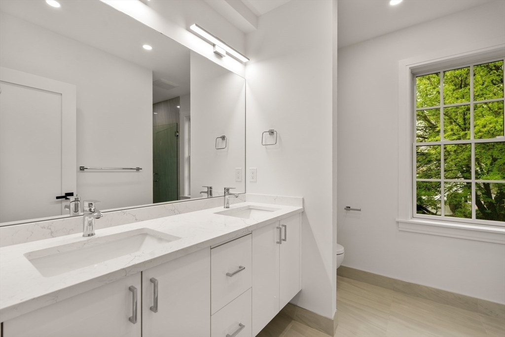 121 Oliver Road Belmont, MA 02478 - Photo 19 of 34 a bathroom with a sink double vanity and a mirror