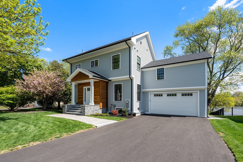 121 Oliver Road Belmont, MA 02478 - Photo 2 of 34 a front view of a house with a yard and trees