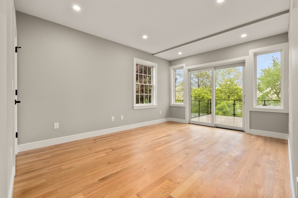 121 Oliver Road Belmont, MA 02478 - Photo 23 of 34 a view of an empty room with a window and wooden floor