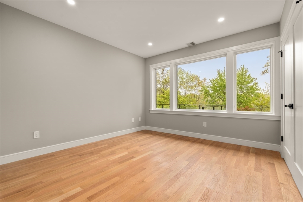 121 Oliver Road Belmont, MA 02478 - Photo 24 of 34 wooden floor in an empty room with a window