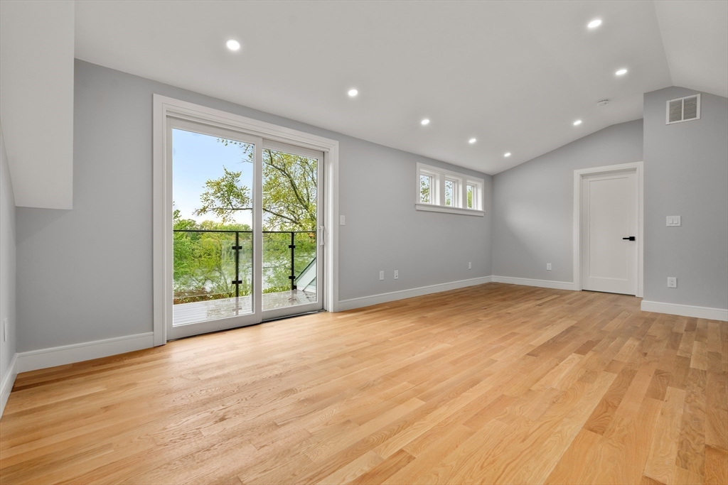 121 Oliver Road Belmont, MA 02478 - Photo 26 of 34 a view of an empty room with wooden floor and a window