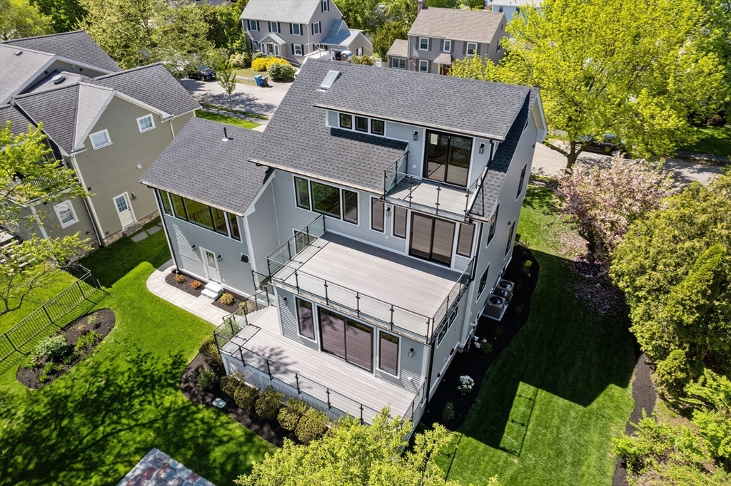 121 Oliver Road Belmont, MA 02478 - Photo 3 of 34 an aerial view of multiple houses with a yard