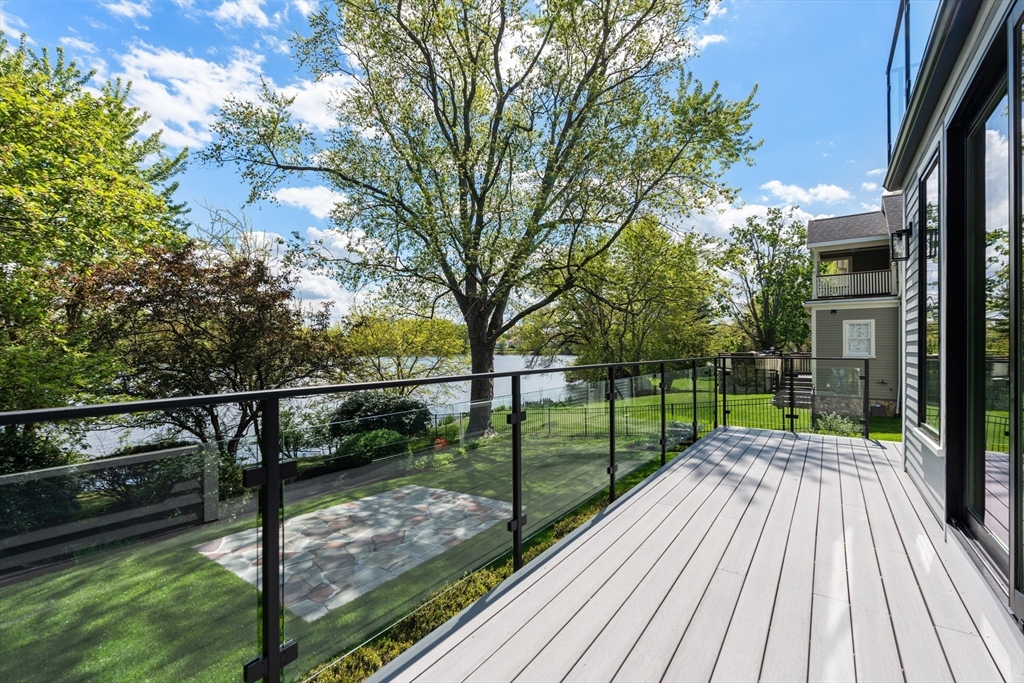 121 Oliver Road Belmont, MA 02478 - Photo 4 of 34 a view of a balcony with wooden floor next to a yard