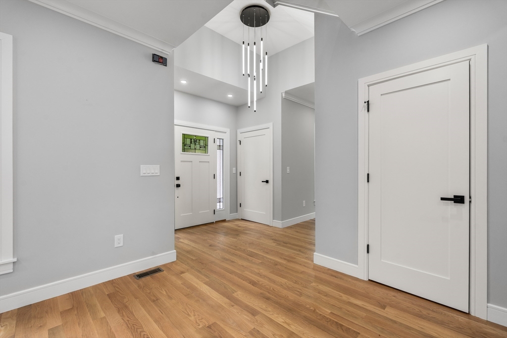121 Oliver Road Belmont, MA 02478 - Photo 5 of 34 wooden floor in an empty room with a window