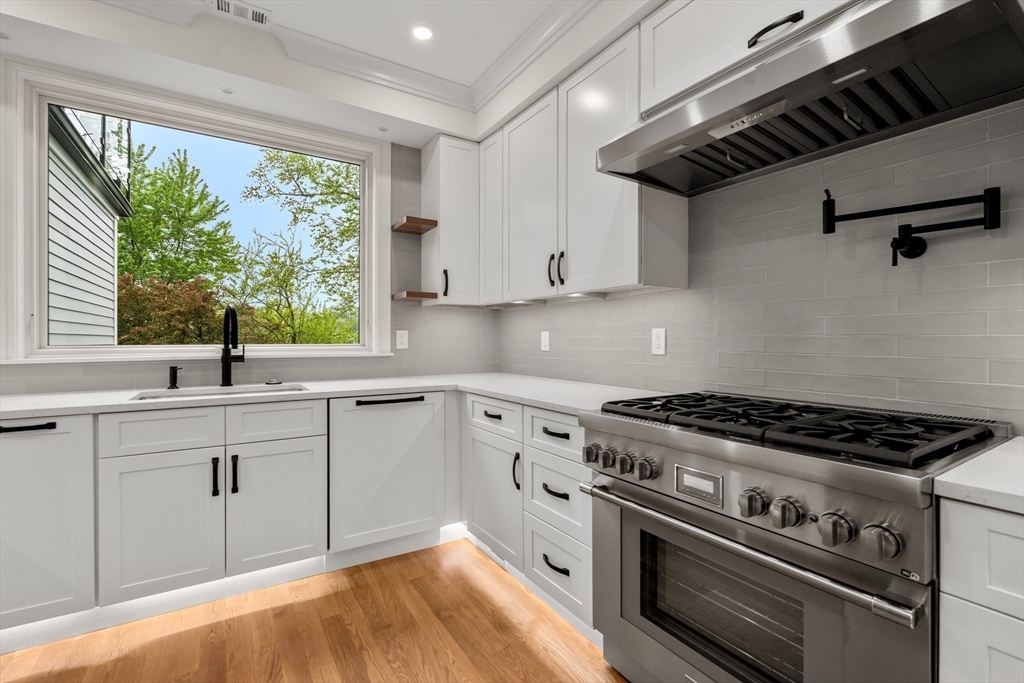 121 Oliver Road Belmont, MA 02478 - Photo 9 of 34 a kitchen with cabinets appliances and a large window