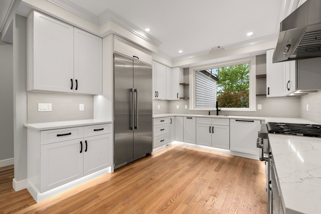 121 Oliver Road Belmont, MA 02478 - Photo 10 of 34 a kitchen with white cabinets and wooden floor