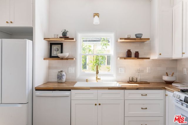 a kitchen with a stove and a white refrigerator