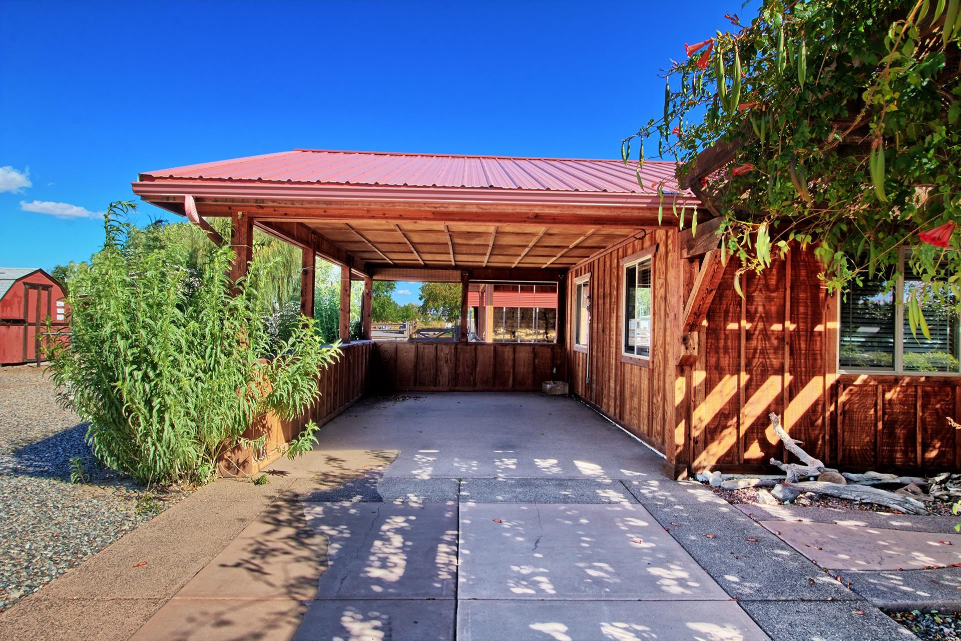 967 18 Road Fruita, CO 81521 - Photo 6 of 39 a view of a backyard with table and chairs under an umbrella