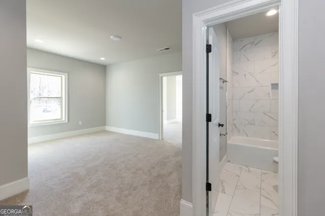 a bathroom with a granite countertop sink a toilet and shower