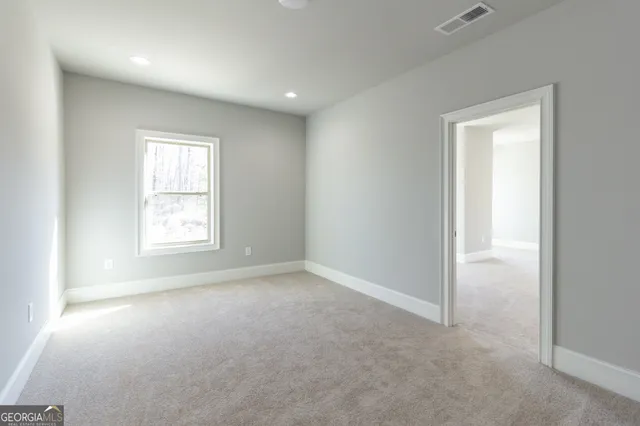 a view of a hallway with wooden floor and stairs