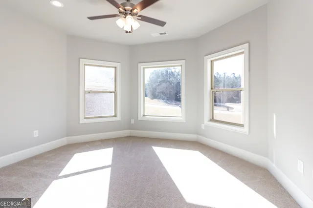 a view of a livingroom with a window and a ceiling fan