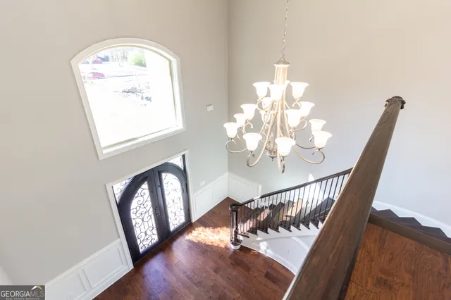 a view of a livingroom with a fireplace a ceiling fan and windows