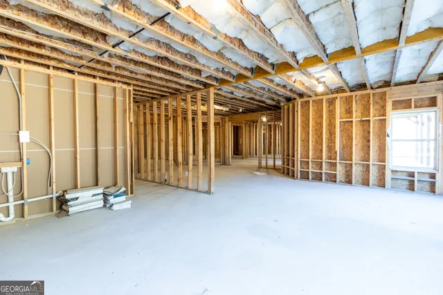 a view of a hallway with wooden floor and entryway