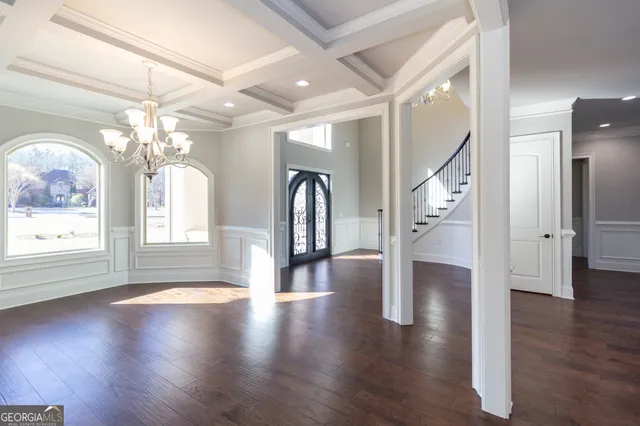 a bathroom with a granite countertop toilet sink and mirror