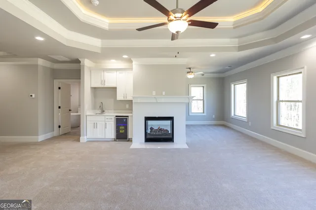 a kitchen with white cabinets and wooden floors