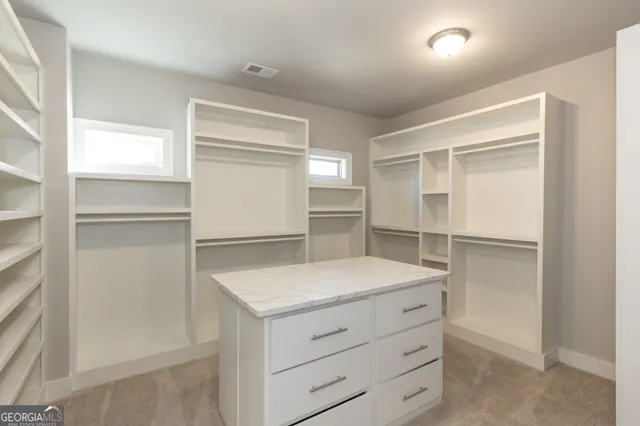 a spacious bathroom with a granite countertop shower a sink and a shower
