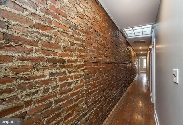 an empty room with wooden floor and closet
