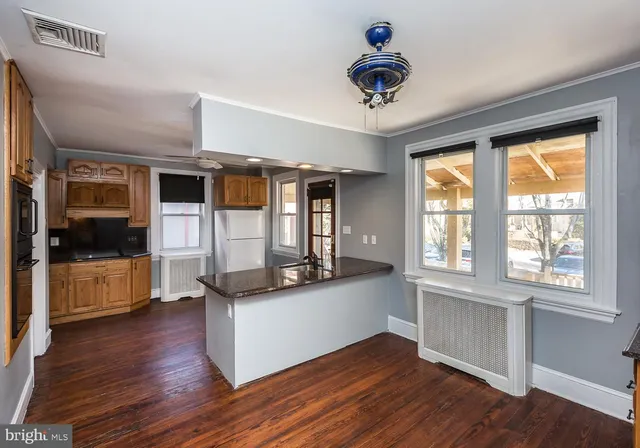 a kitchen with stainless steel appliances granite countertop a stove and wooden floor