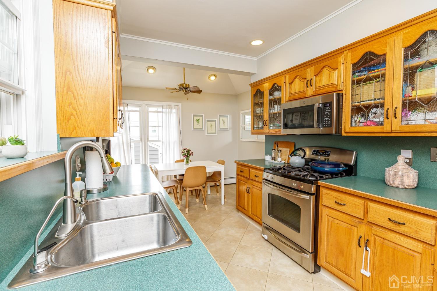 215 Hillside Road Elizabeth, NJ 07208 - Photo 15 of 37 a kitchen with stainless steel appliances granite countertop a stove a sink and a microwave