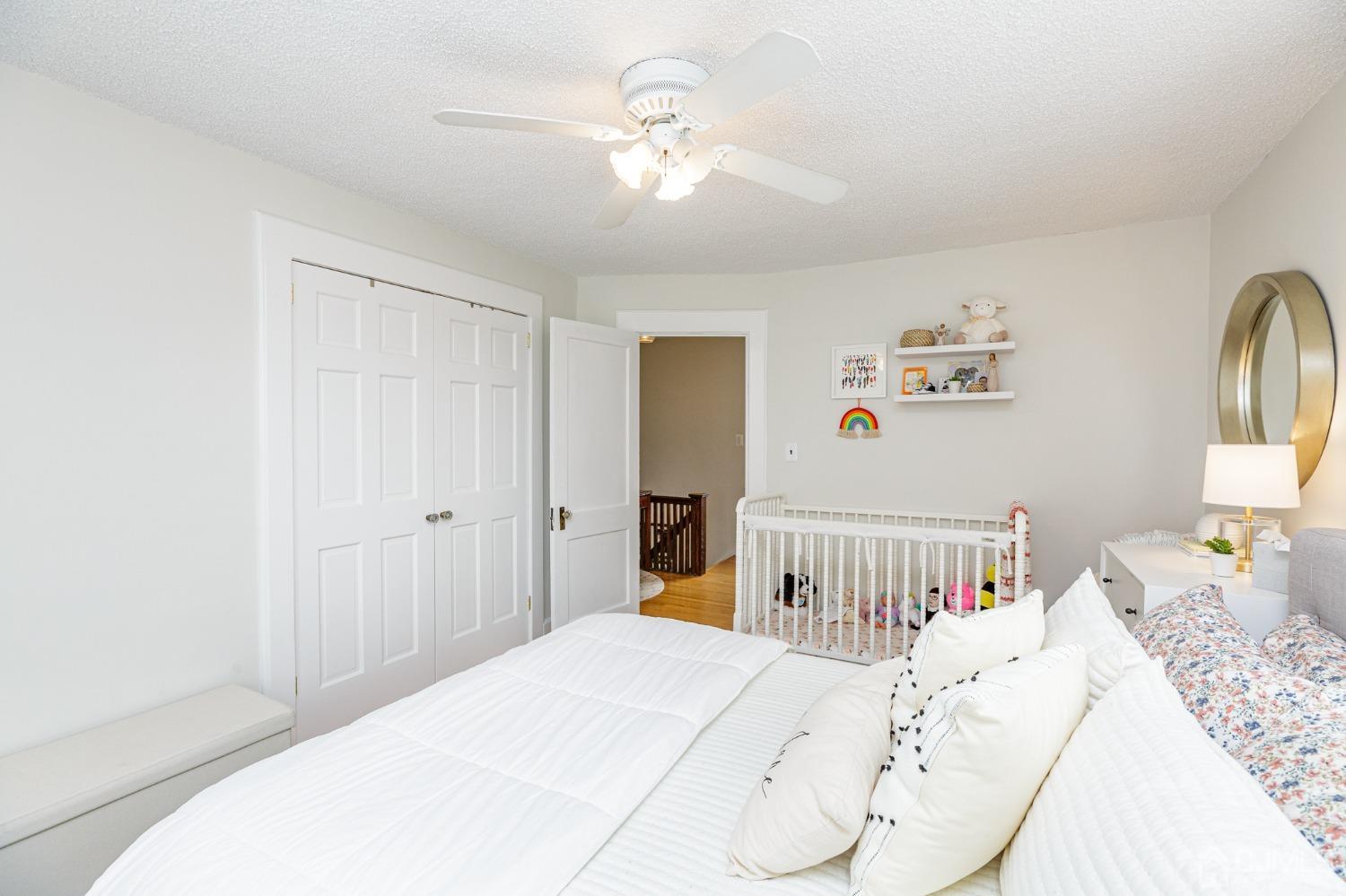 215 Hillside Road Elizabeth, NJ 07208 - Photo 20 of 37 a bedroom with a bed and a chandelier