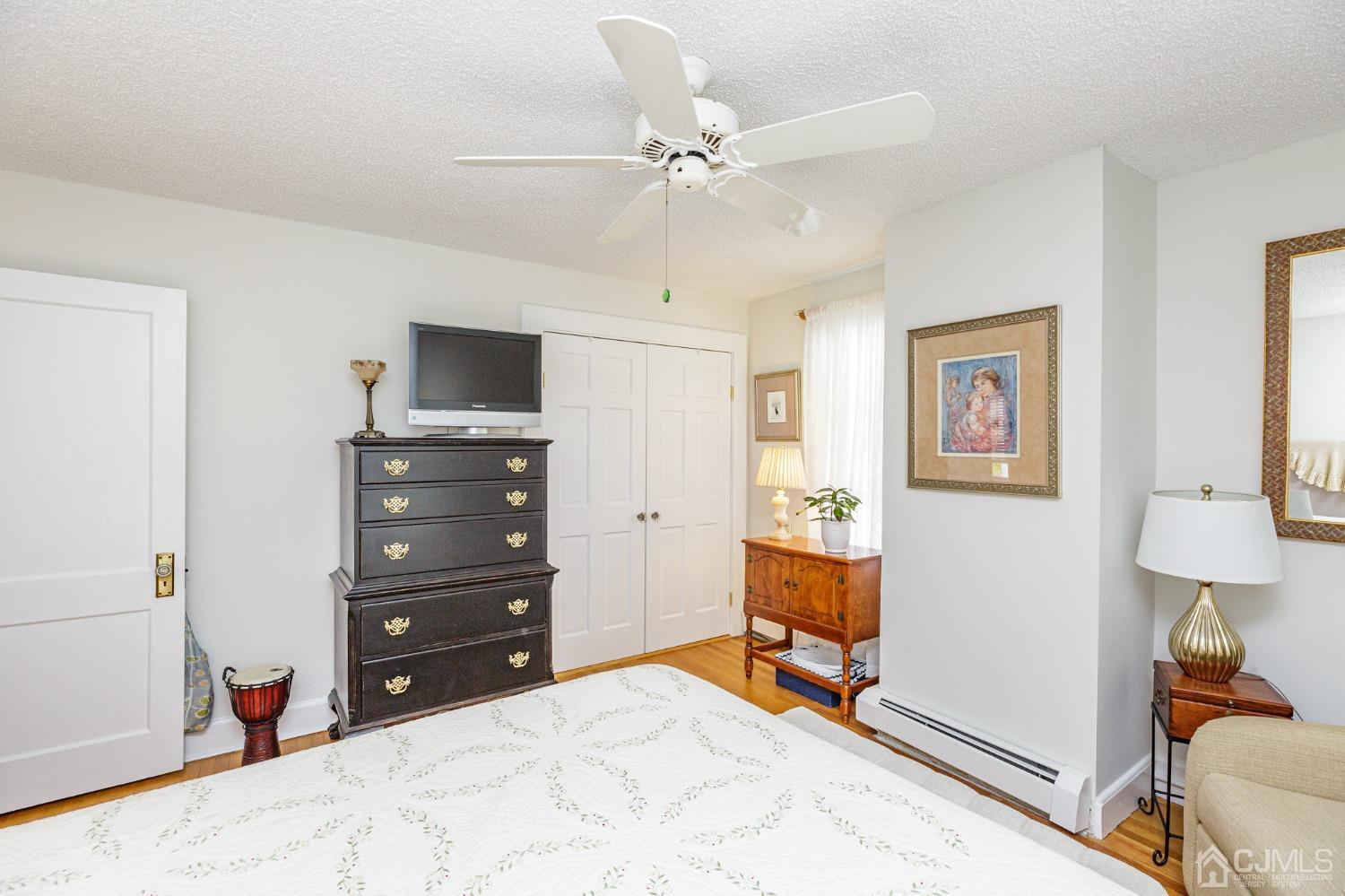 215 Hillside Road Elizabeth, NJ 07208 - Photo 22 of 37 a bedroom with a bed and a chandelier