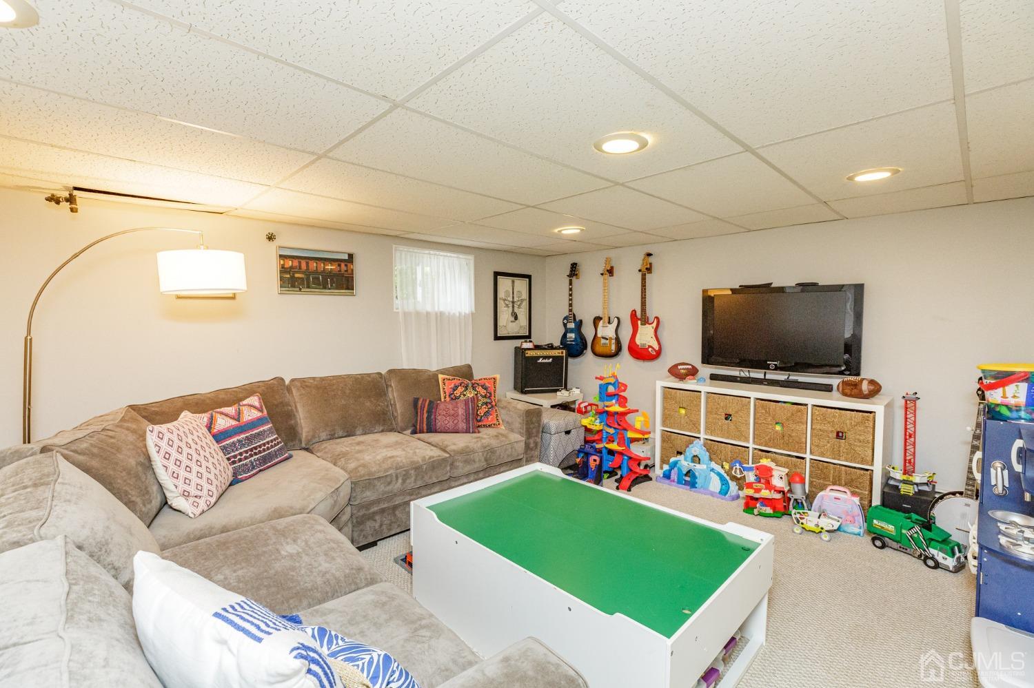 215 Hillside Road Elizabeth, NJ 07208 - Photo 26 of 37 a living room with furniture and a flat screen tv