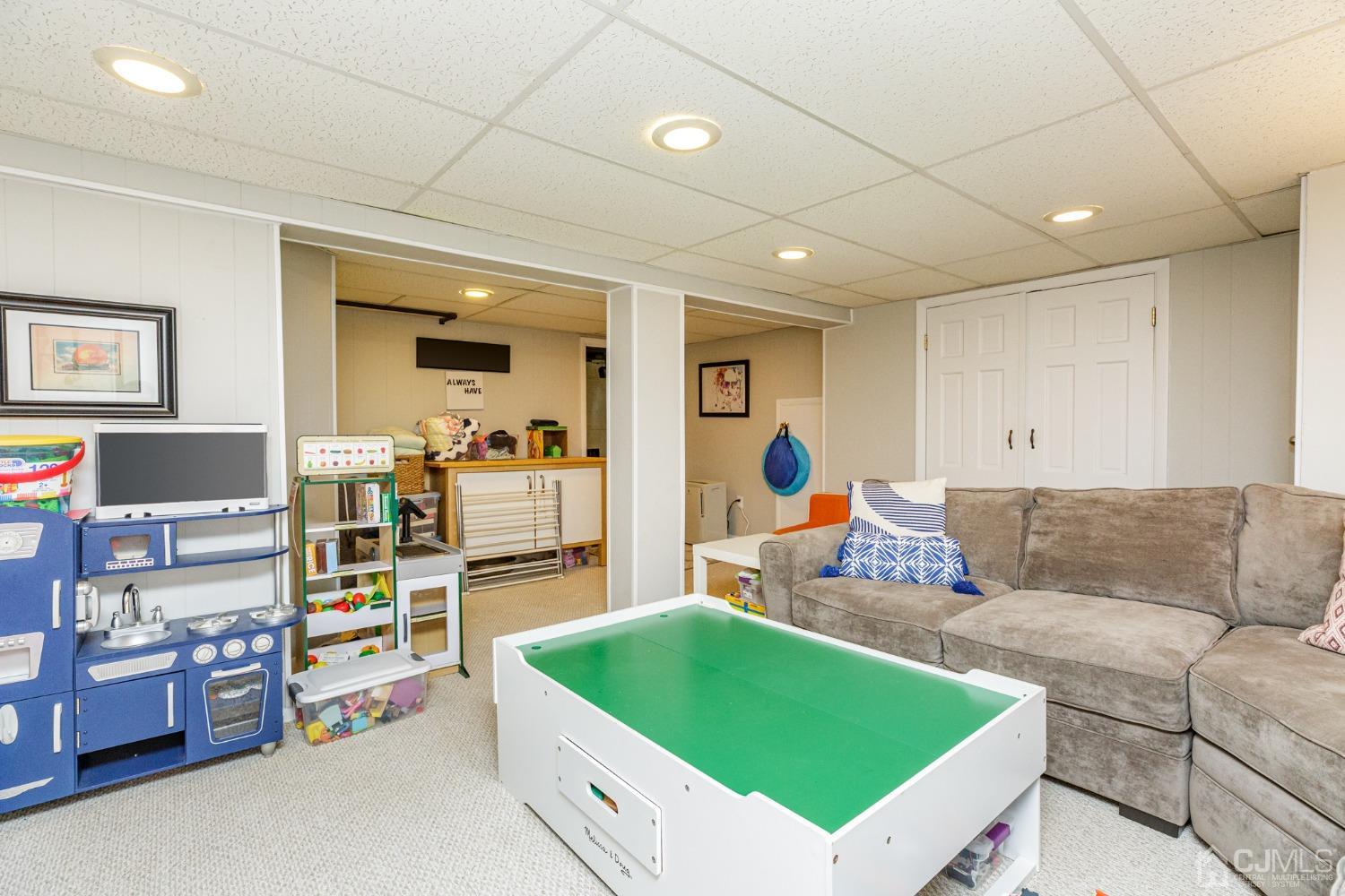 215 Hillside Road Elizabeth, NJ 07208 - Photo 28 of 37 a living room with furniture and a flat screen tv