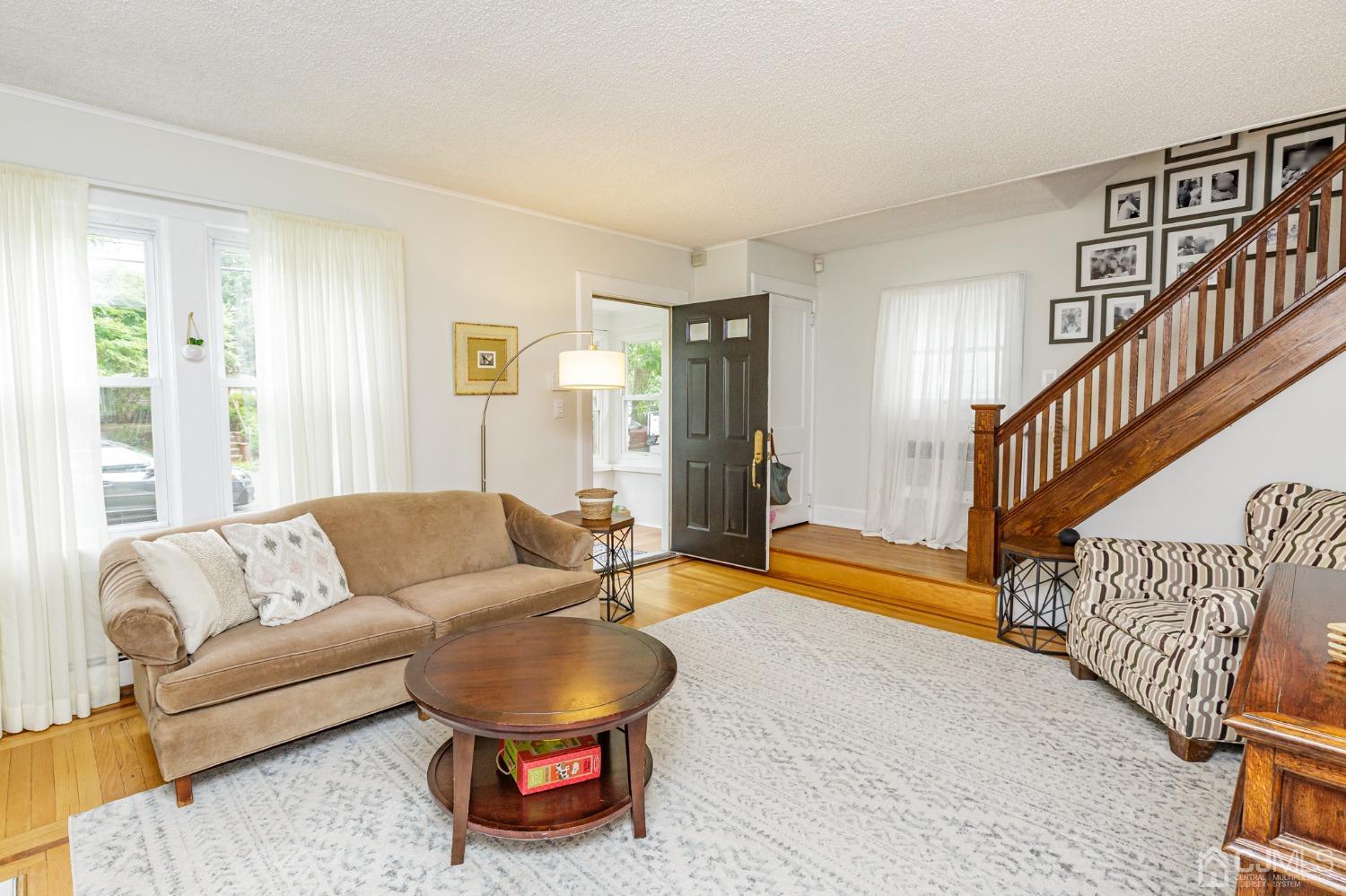 215 Hillside Road Elizabeth, NJ 07208 - Photo 6 of 37 a living room with furniture and a rug