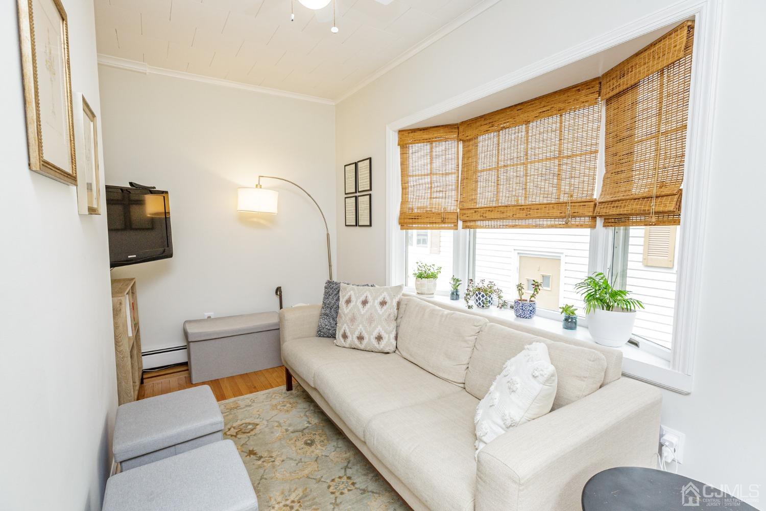 215 Hillside Road Elizabeth, NJ 07208 - Photo 8 of 37 a living room with furniture and a large window