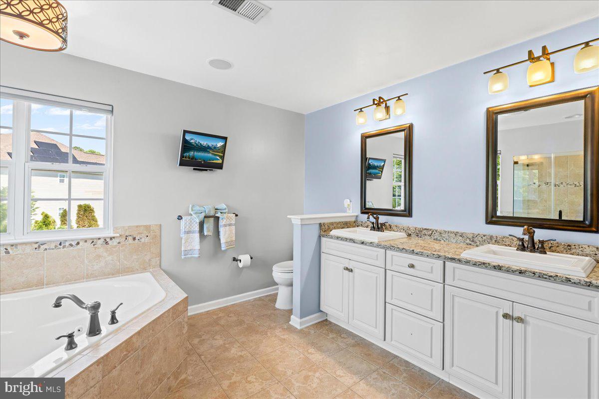 2650 Valhalla Road Vineland, NJ 08361 - Photo 33 of 49 a spacious bathroom with a granite countertop tub sink and mirror